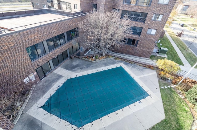 community pool featuring a patio and fence