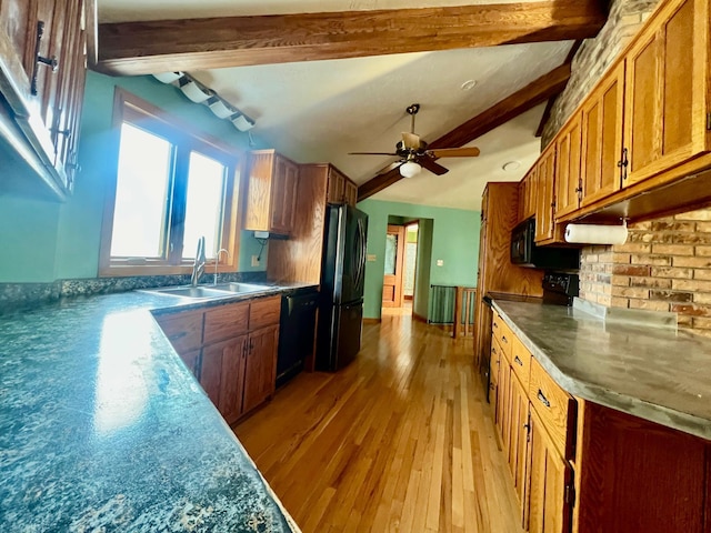 kitchen featuring ceiling fan, sink, light hardwood / wood-style flooring, beamed ceiling, and black appliances