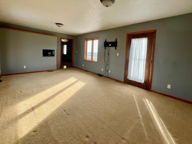 unfurnished living room featuring carpet