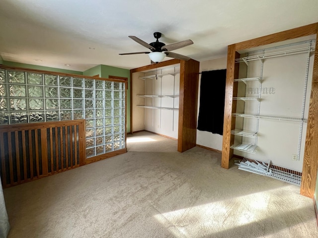 interior space with carpet floors and ceiling fan