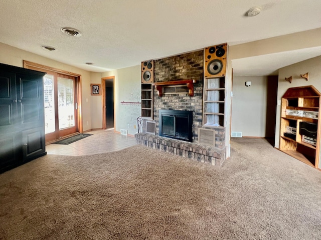 unfurnished living room featuring a fireplace, carpet, and a textured ceiling