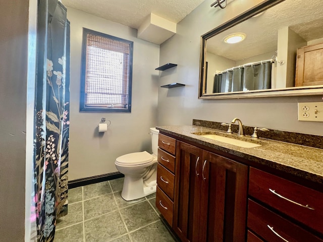 bathroom featuring a shower with shower curtain, a textured ceiling, vanity, and toilet