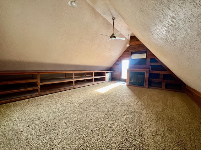 additional living space with carpet flooring, ceiling fan, lofted ceiling, and a textured ceiling