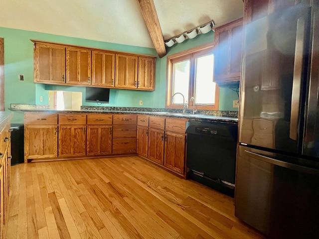 64345 370th St, Ortonville, MN 56278 - kitchen featuring freestanding refrigerator, black dishwasher, a sink, light wood-style flooring, and brown cabinets