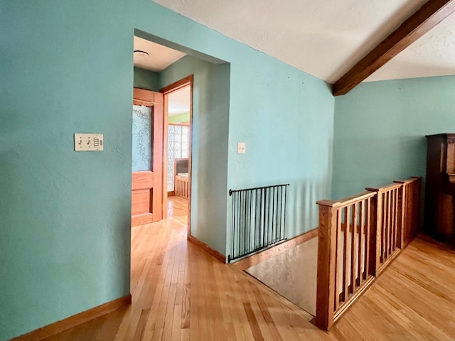64345 370th St, Ortonville, MN 56278 - corridor featuring an upstairs landing, hardwood / wood-style flooring, beam ceiling, and baseboards