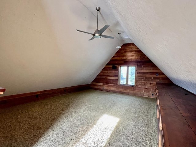 64345 370th St, Ortonville, MN 56278 - additional living space featuring wooden walls, vaulted ceiling, ceiling fan, and carpet