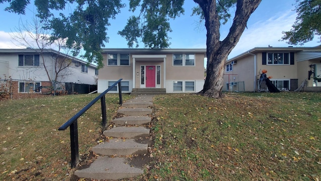 raised ranch with a front lawn