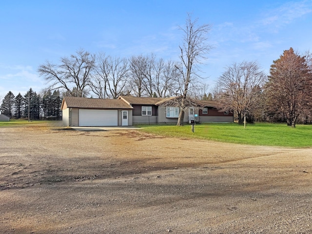 ranch-style house featuring a garage and a front lawn