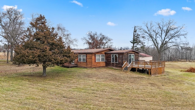 rear view of property with a yard and a deck