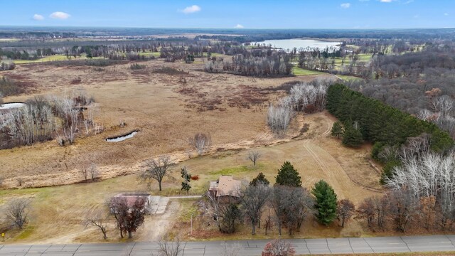 birds eye view of property featuring a water view and a rural view