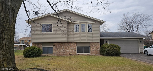 9725 Thomas Ave N, Brooklyn Park, MN 55444 - view of side of property with asphalt driveway, an attached garage, brick siding, and a lawn