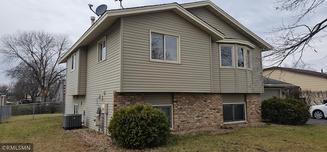 9725 Thomas Ave N, Brooklyn Park, MN 55444 - view of home's exterior with a central AC unit and brick siding