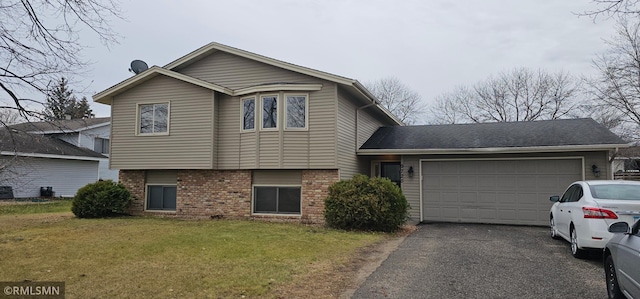 9725 Thomas Ave N, Brooklyn Park, MN 55444 - split level home with brick siding, a garage, driveway, and a front yard