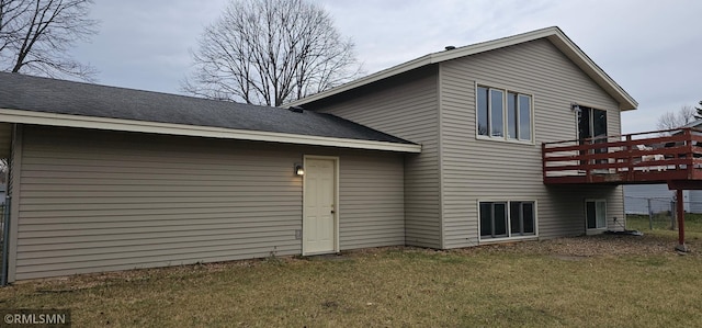 9725 Thomas Ave N, Brooklyn Park, MN 55444 - rear view of house featuring a yard, a wooden deck, and roof with shingles