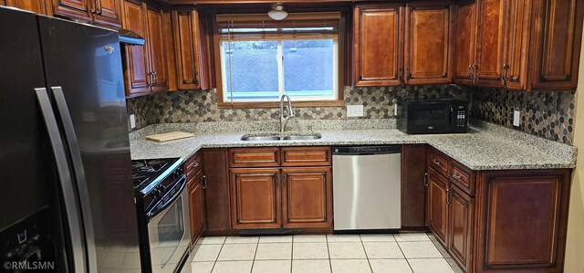 9725 Thomas Ave N, Brooklyn Park, MN 55444 - kitchen featuring appliances with stainless steel finishes, light tile patterned floors, decorative backsplash, and light stone countertops