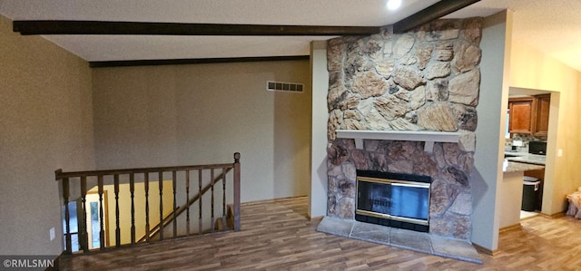 9725 Thomas Ave N, Brooklyn Park, MN 55444 - unfurnished living room with beamed ceiling, wood finished floors, and a fireplace