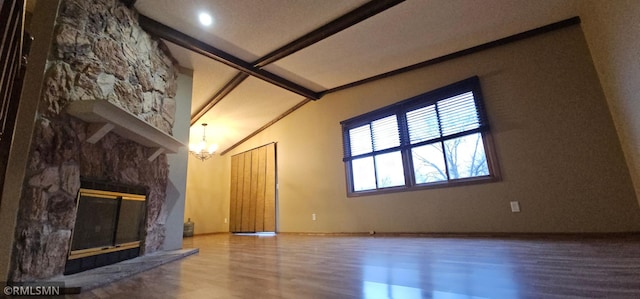 9725 Thomas Ave N, Brooklyn Park, MN 55444 - unfurnished living room featuring wood finished floors, a fireplace, and a chandelier