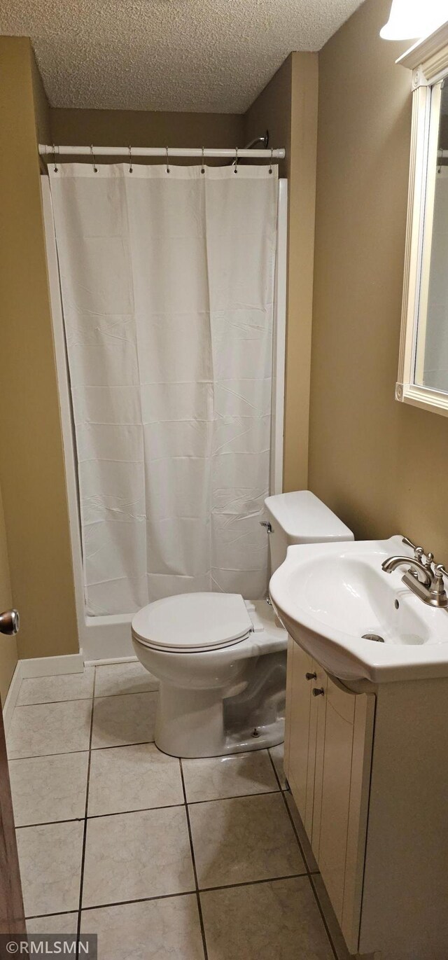 9725 Thomas Ave N, Brooklyn Park, MN 55444 - bathroom with a textured ceiling, vanity, tile patterned floors, and a shower with curtain