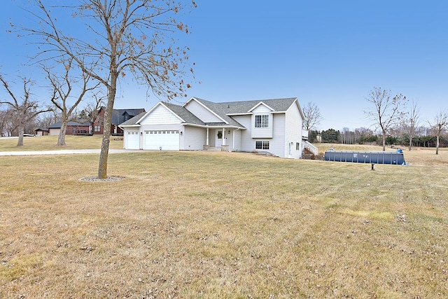 view of front of home with a garage and a front yard