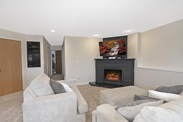 living area with baseboards, visible vents, carpet flooring, a fireplace, and recessed lighting