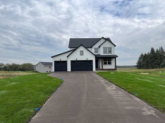 modern farmhouse featuring a garage and a front yard