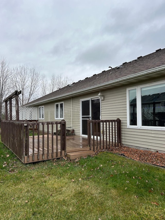 back of house with a lawn and a wooden deck