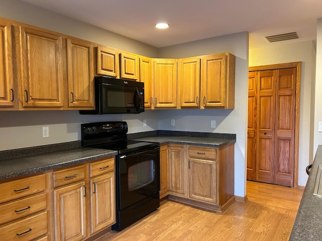 kitchen with black appliances and light wood-type flooring