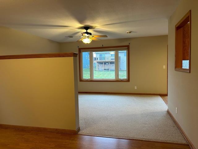 unfurnished room with ceiling fan, light hardwood / wood-style floors, and a textured ceiling