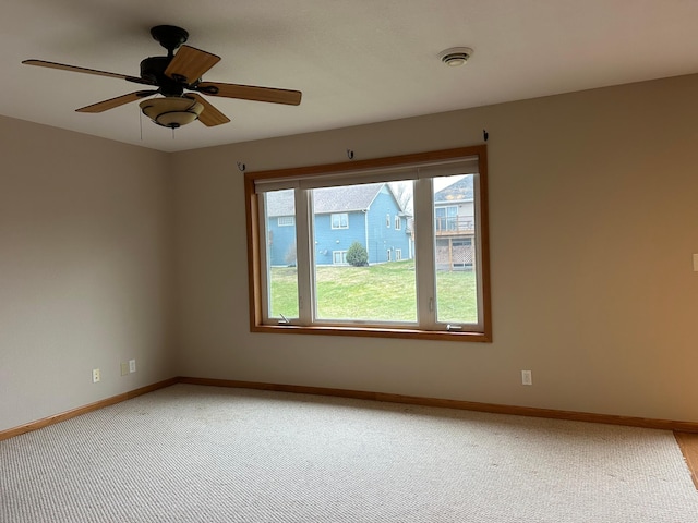 unfurnished room with carpet and ceiling fan