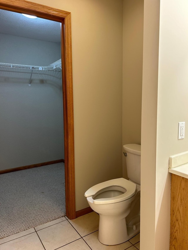 bathroom featuring toilet and tile patterned floors