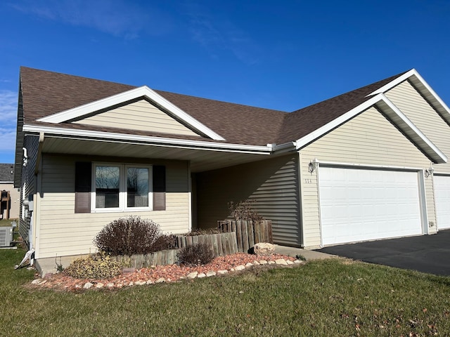 single story home featuring a front yard, central AC, and a garage