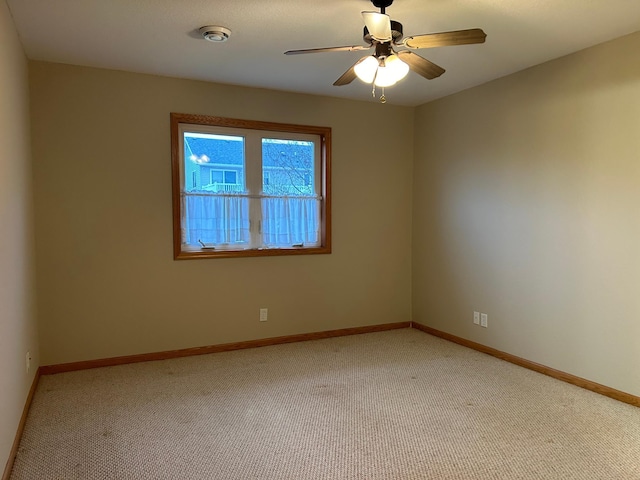 spare room with light carpet and ceiling fan