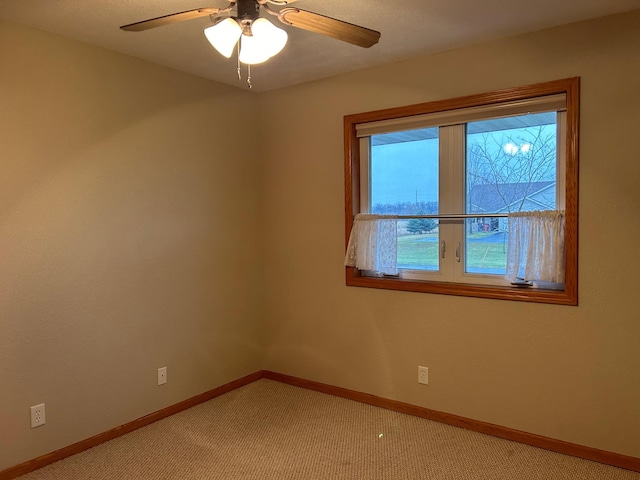 carpeted empty room featuring ceiling fan