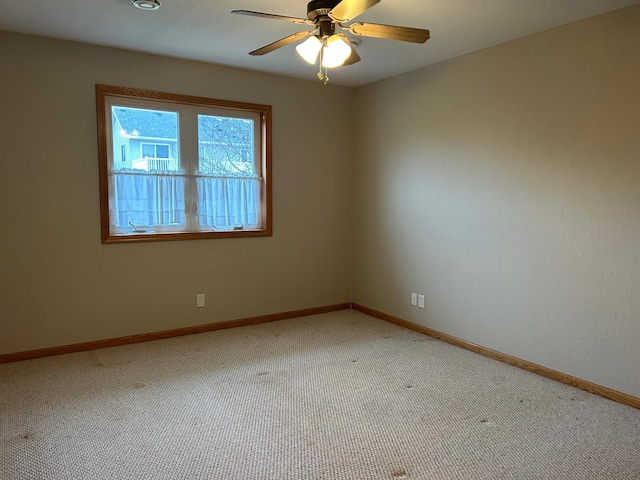 unfurnished room with carpet and ceiling fan