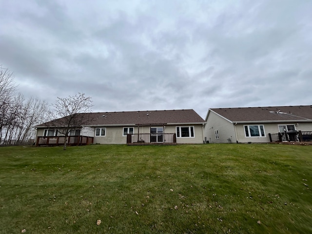 rear view of property featuring a yard