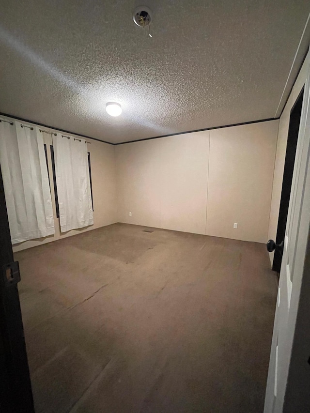 unfurnished bedroom featuring carpet floors and a textured ceiling