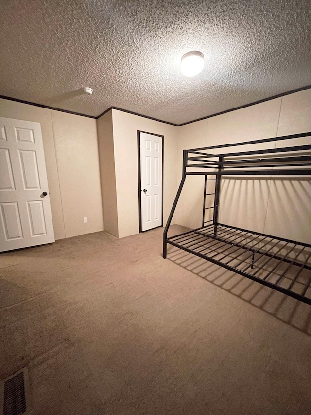 unfurnished bedroom with carpet flooring and a textured ceiling