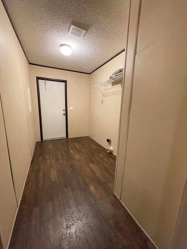 interior space featuring a textured ceiling and dark hardwood / wood-style floors