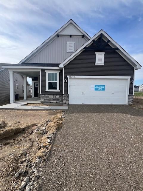 19510 103rd Ave, Corcoran, MN 55374 - craftsman-style house featuring dirt driveway, board and batten siding, and stone siding
