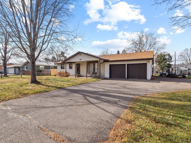 ranch-style home with a front lawn, covered porch, and a garage