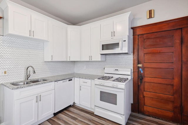 kitchen with sink, dark hardwood / wood-style floors, white appliances, decorative backsplash, and white cabinets