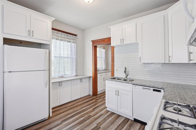 kitchen featuring decorative backsplash, white appliances, sink, hardwood / wood-style flooring, and white cabinets