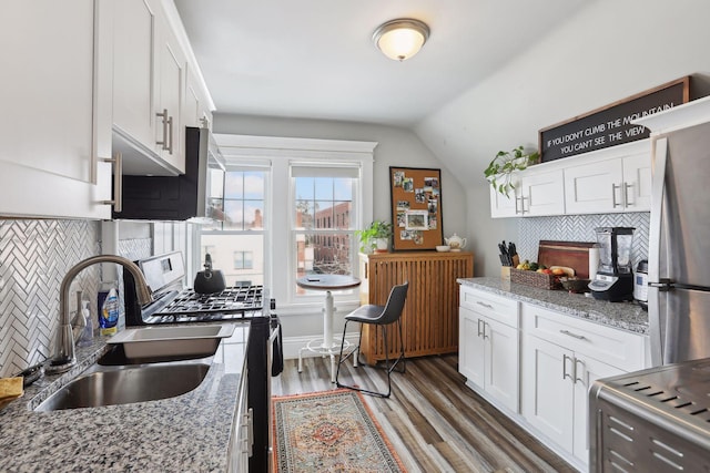 kitchen featuring white cabinetry, sink, light stone countertops, and appliances with stainless steel finishes