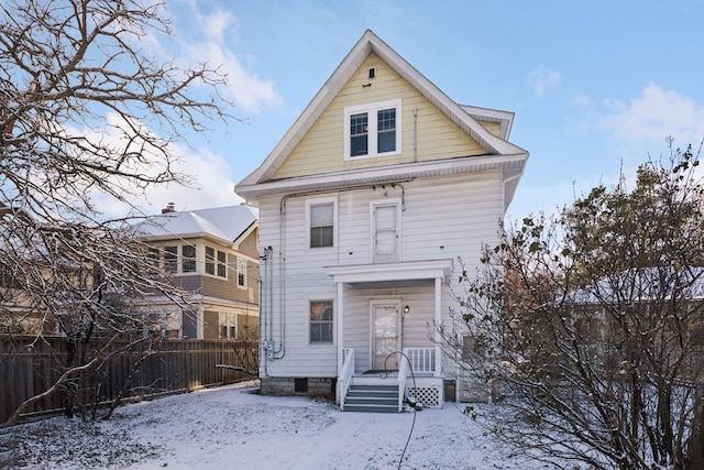 view of snow covered rear of property