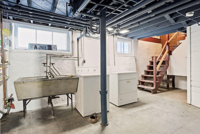 basement with sink and washing machine and dryer