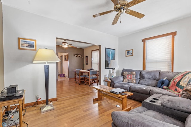 living room with ceiling fan and light wood-type flooring