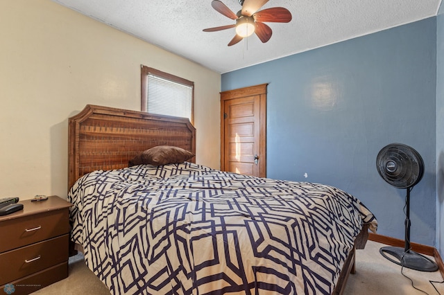 carpeted bedroom featuring a textured ceiling and ceiling fan