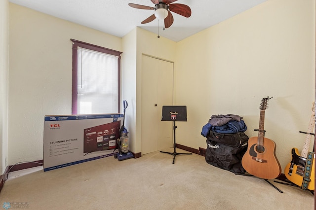 misc room with ceiling fan and light colored carpet