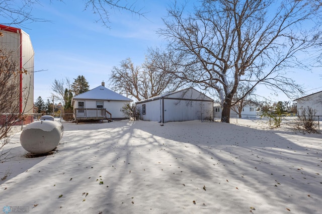 exterior space featuring a wooden deck and an outbuilding