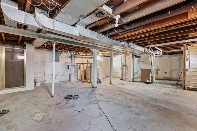 basement with washer / clothes dryer and heating unit